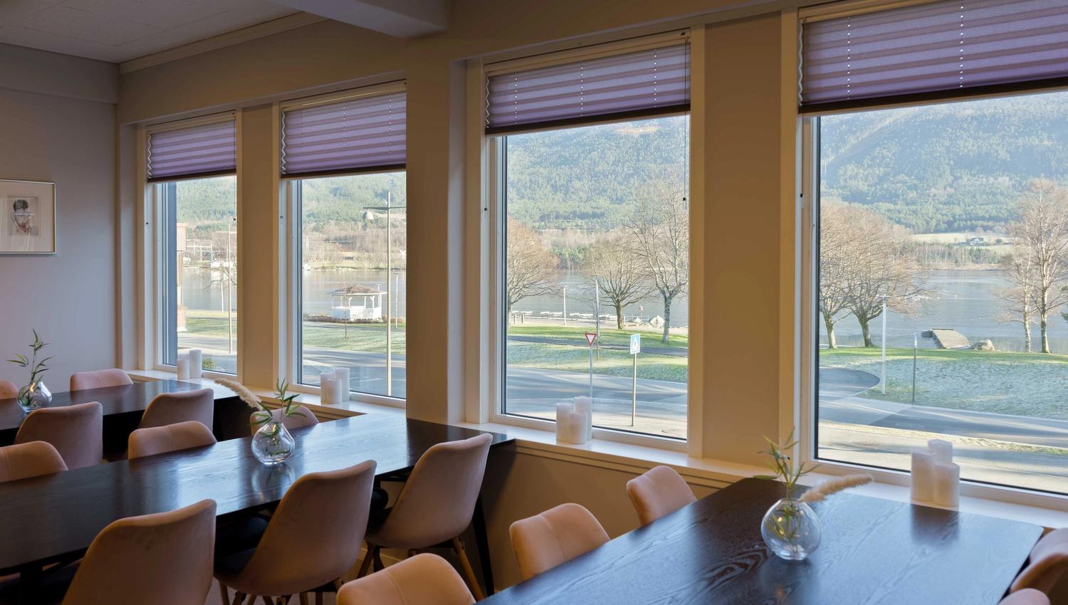 Dining area at Husnes Sentrum Hotel with a beautiful fjord view.