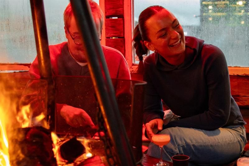 Two people sitting by the fire pit