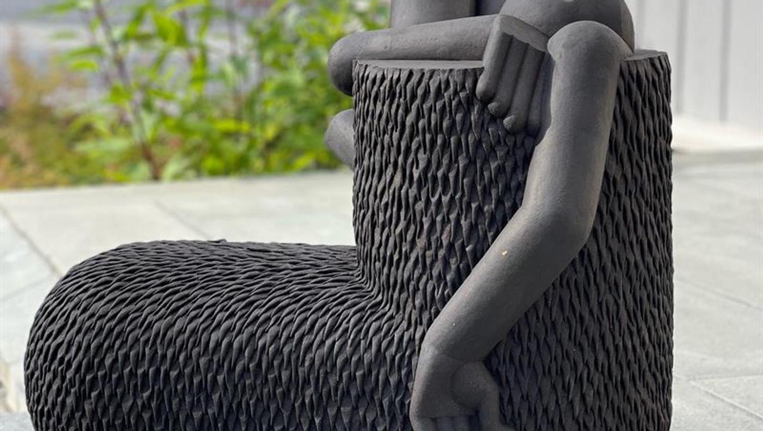 Black sculpture looing like boots