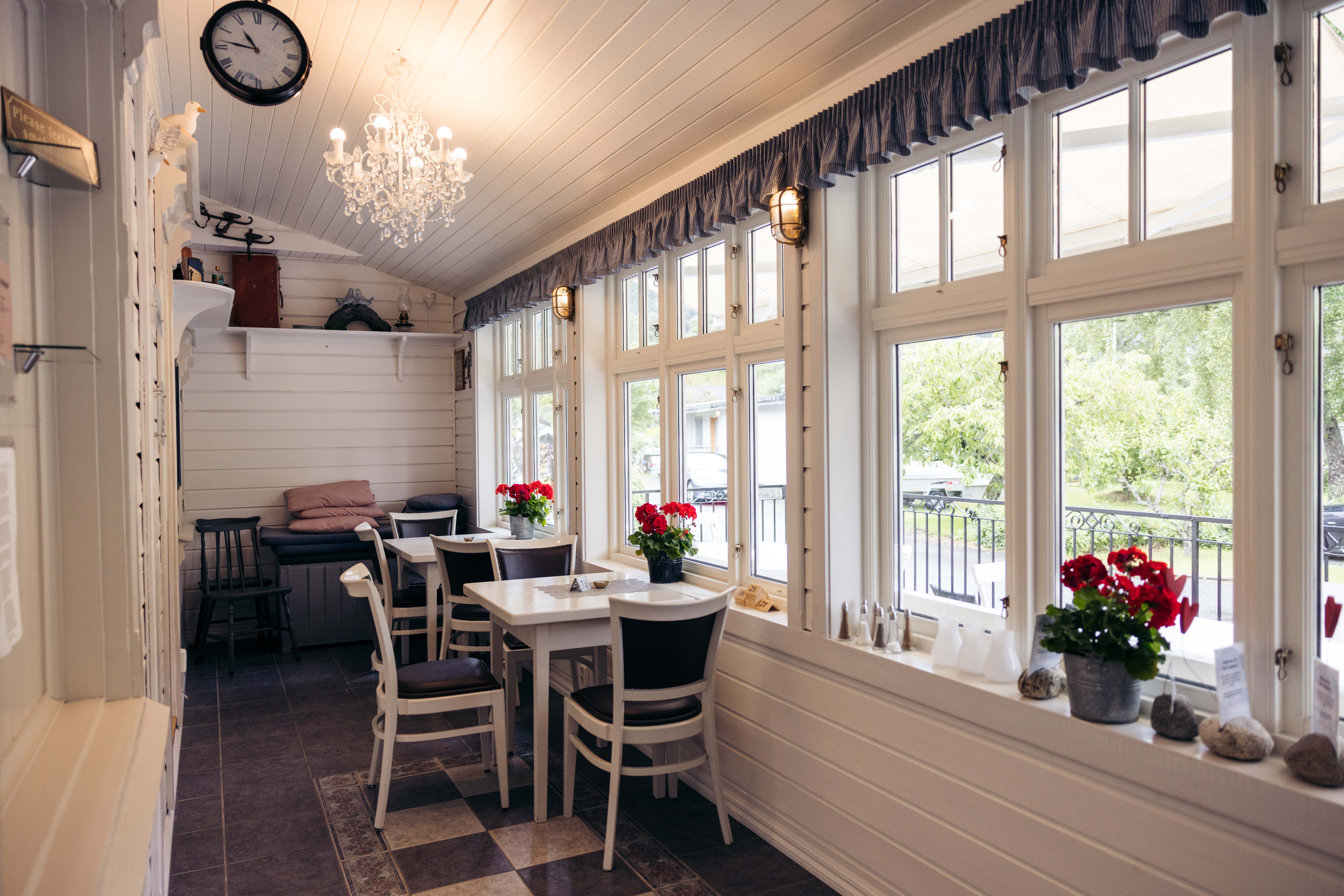 A couple of tables and chairs by the entrance to the bakery.