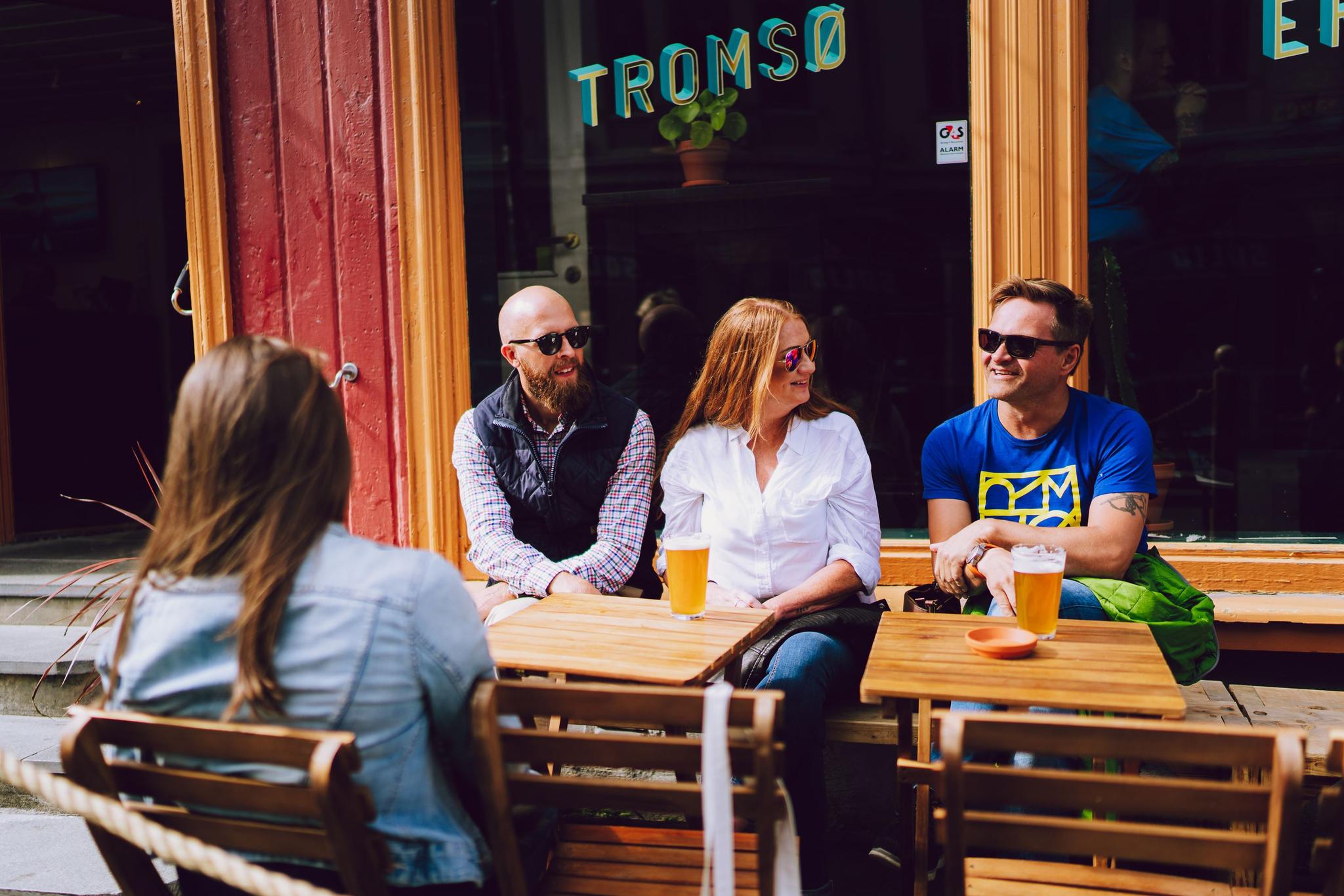 People sitting at outdoor tables.