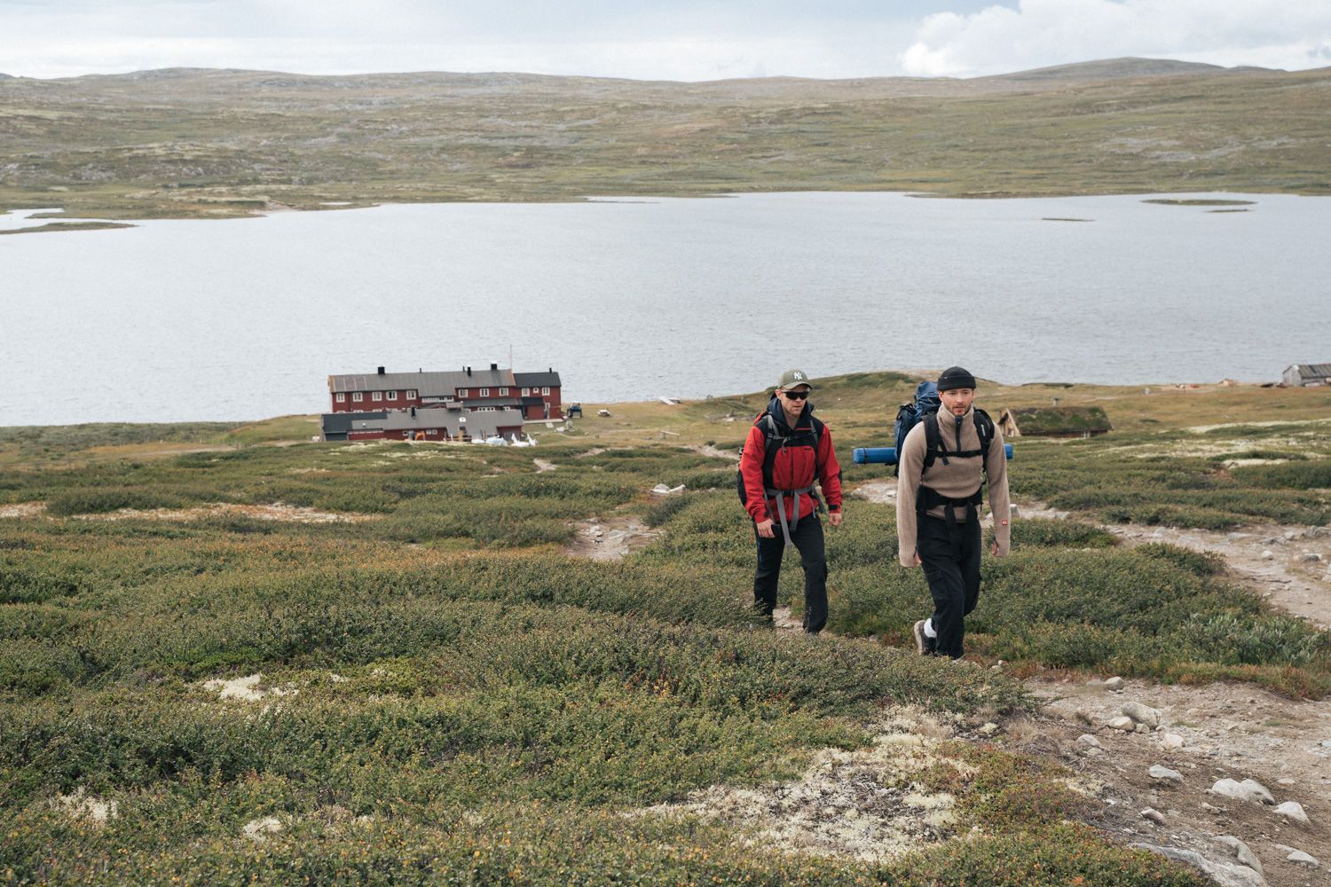 Two hikers leaving the mountain lodge.