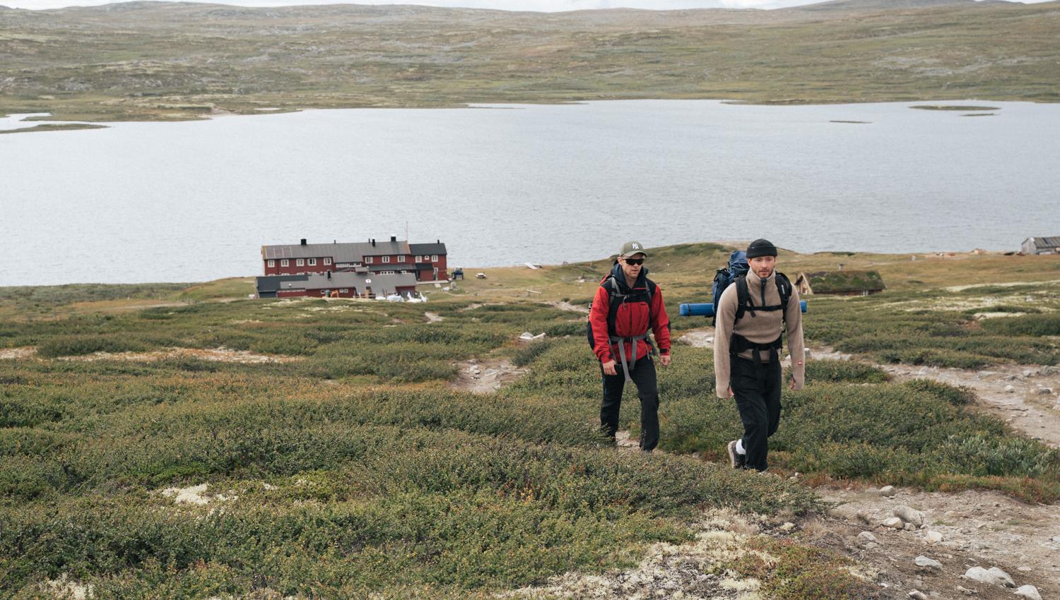 Two hikers leaving the mountain lodge.