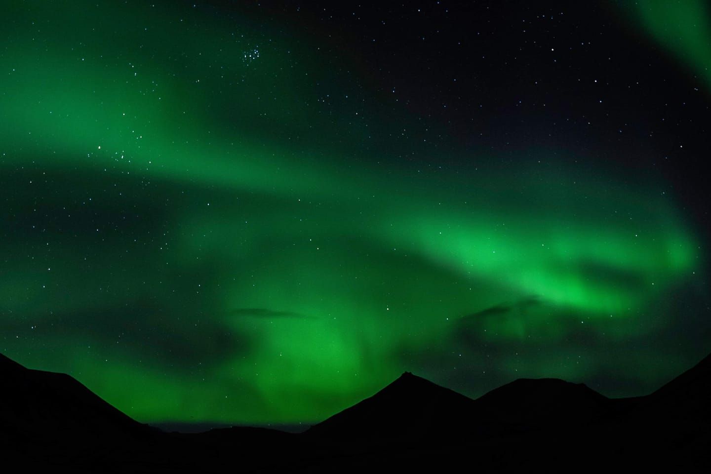 Northern lights shining above mountains