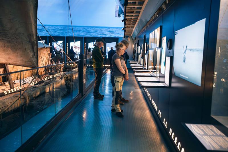People reading information posters in the exhibition
