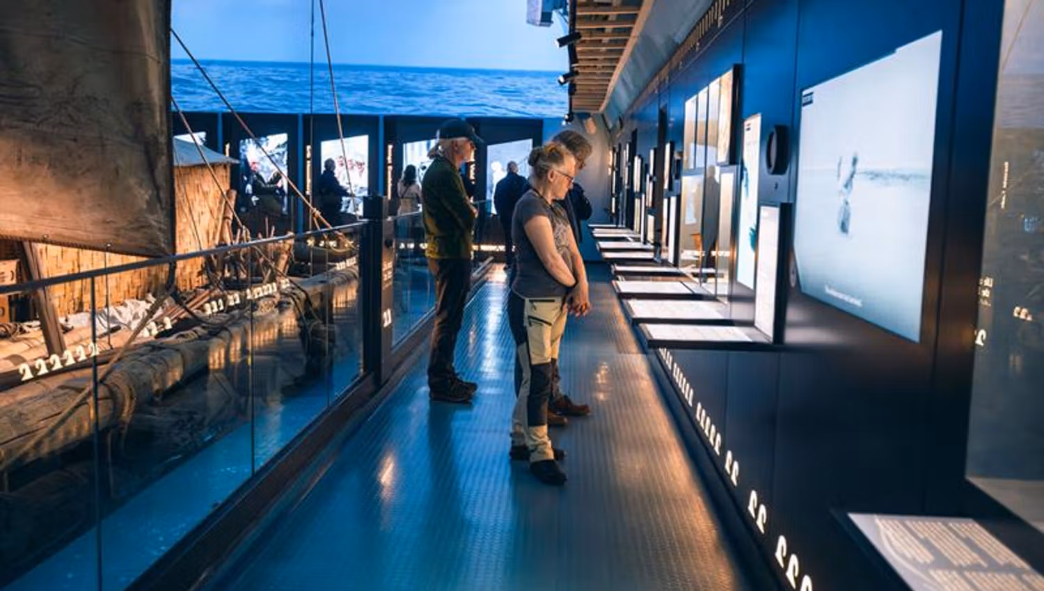 People reading information posters in the exhibition
