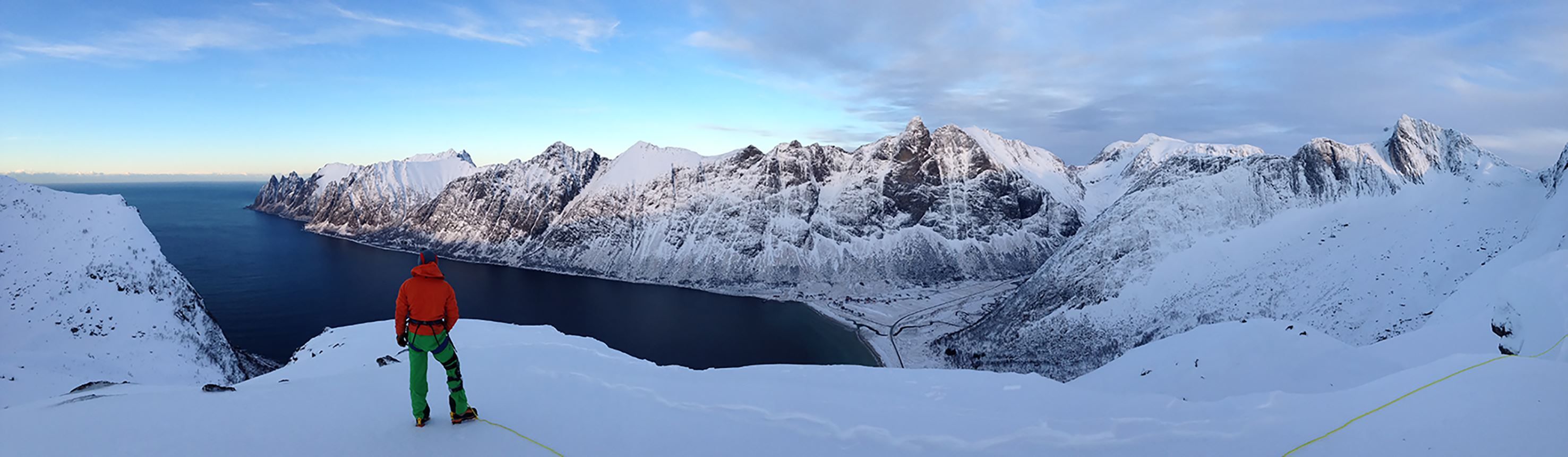 A person enjoying panoramic views of the majestic mountains on Senja.