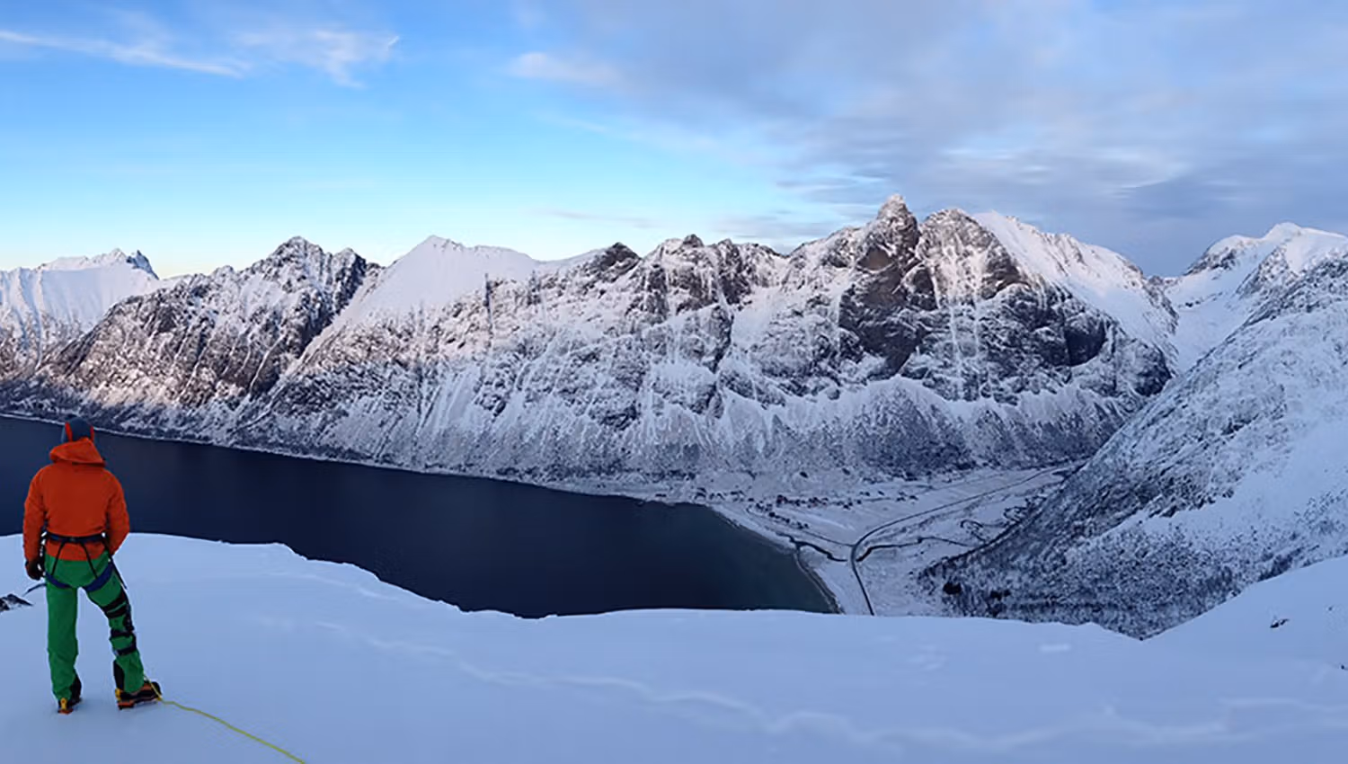 A person enjoying panoramic views of the majestic mountains on Senja.