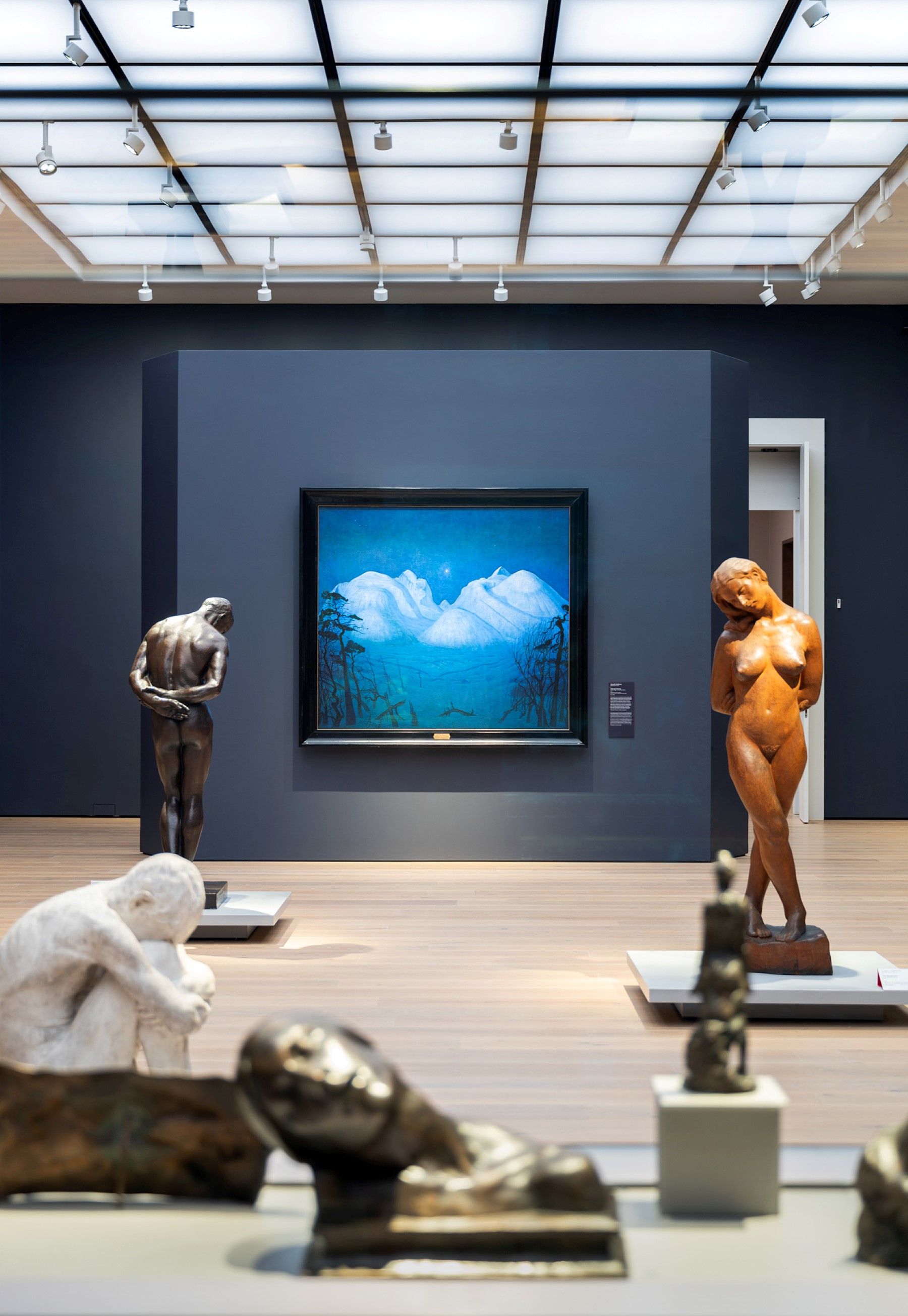 Sculptures and a painting in an exhibition.