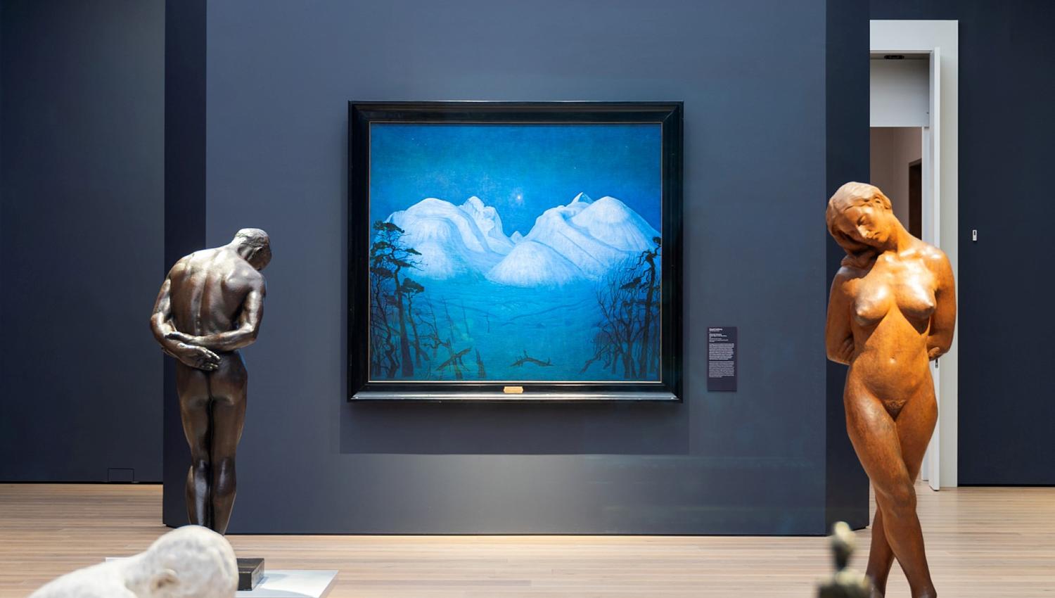 Sculptures and a painting in an exhibition.