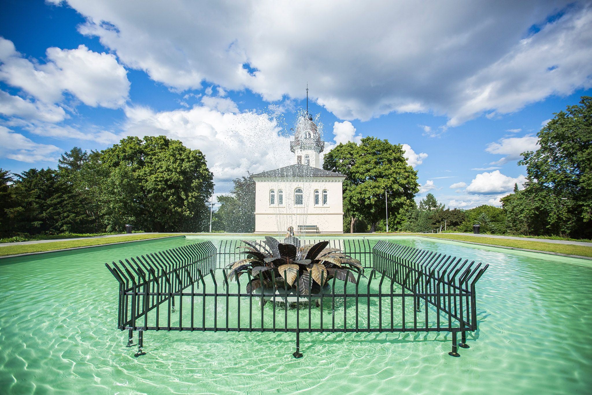 The pool with a fountain in the middle at the top of the park
