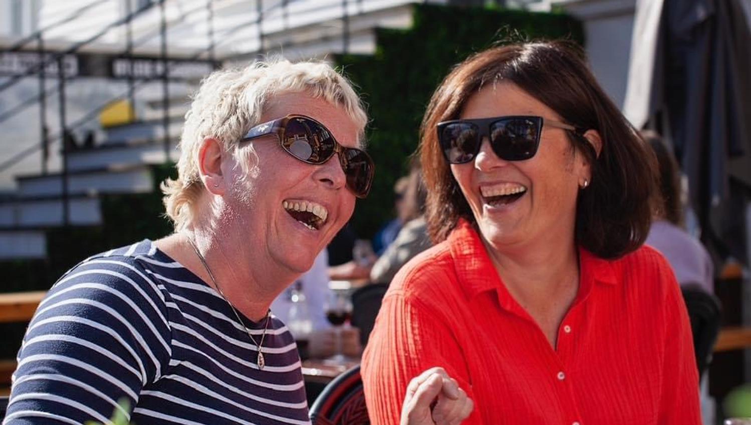 Smiling guests enjoying themselves at the outdoor seating.