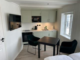 cozy kitchen nook with tv and dining table for two.