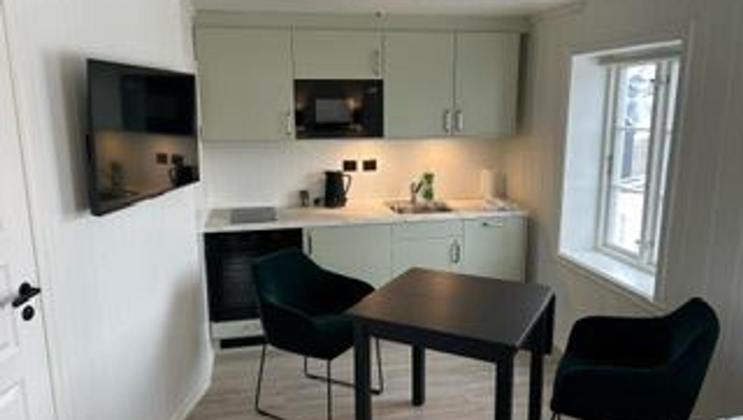 cozy kitchen nook with tv and dining table for two.