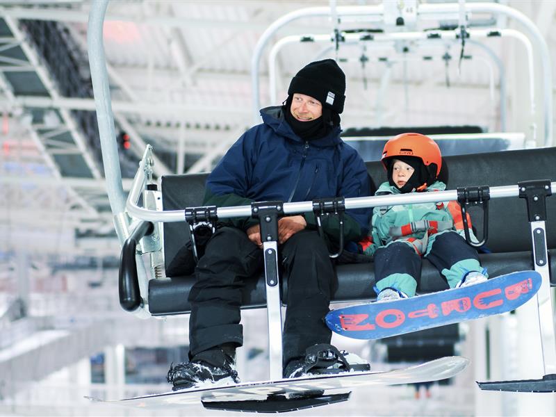 Dad and junior having fun. Indoor alpine skiing at SNØ close by Oslo