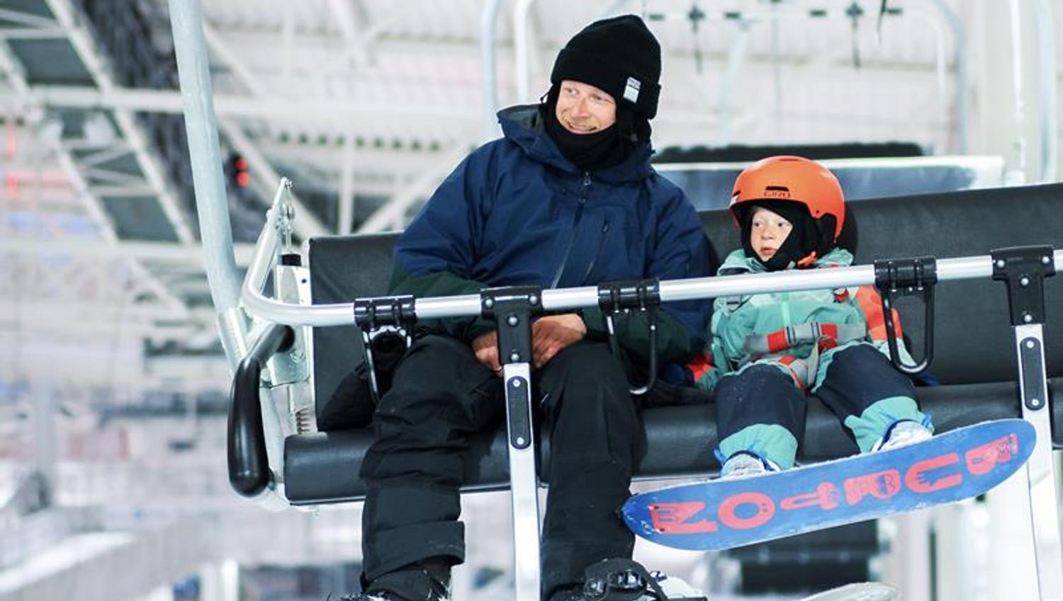 Dad and junior having fun. Indoor alpine skiing at SNØ close by Oslo