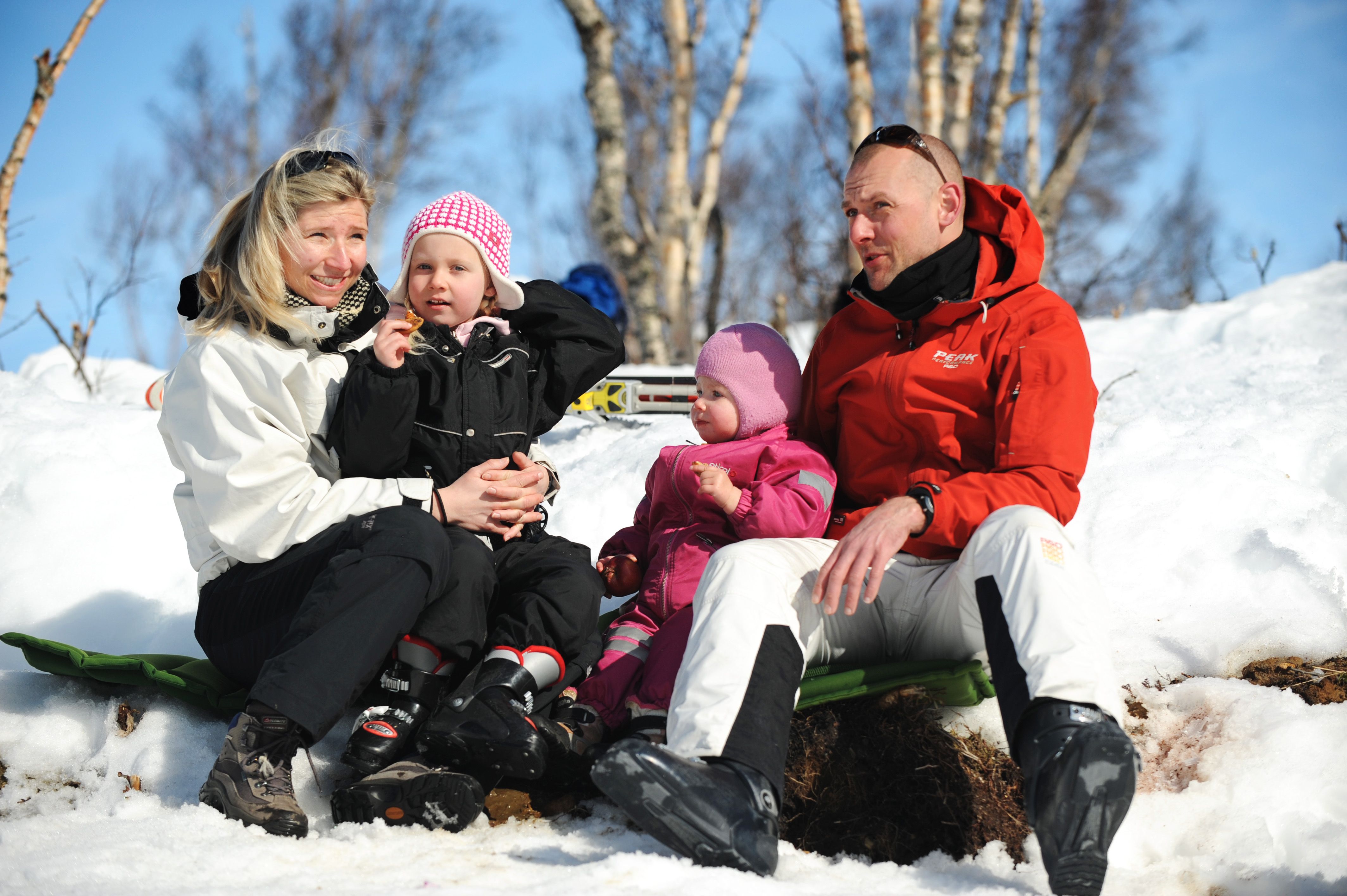 Family taking a short break from skiing, photo