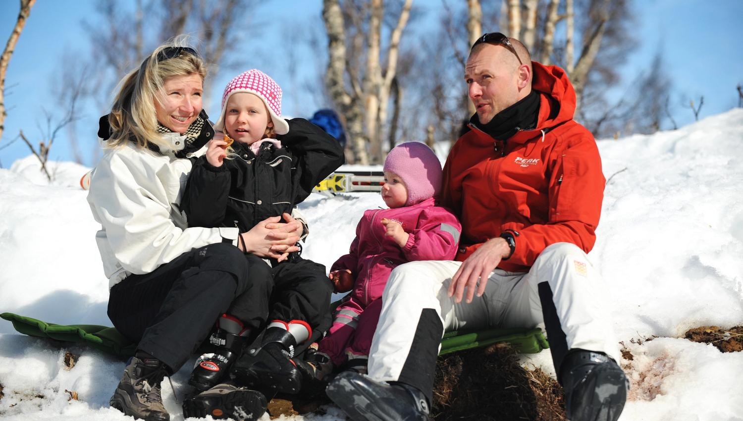 Family taking a short break from skiing, photo