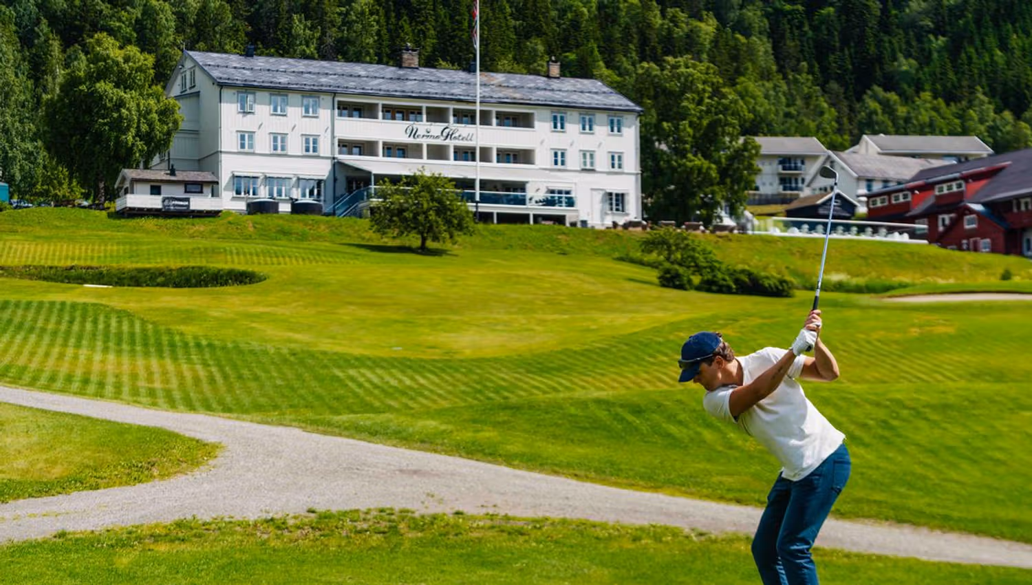 Golfer on a fairway near the clubhouse.
