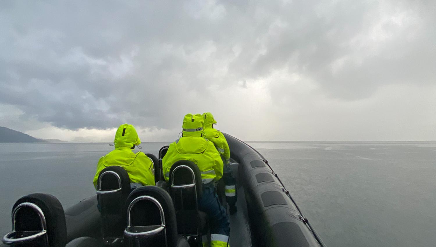 Adventurous passengers on a RIB boat experience the dramatic weather over the Hardangerfjord.