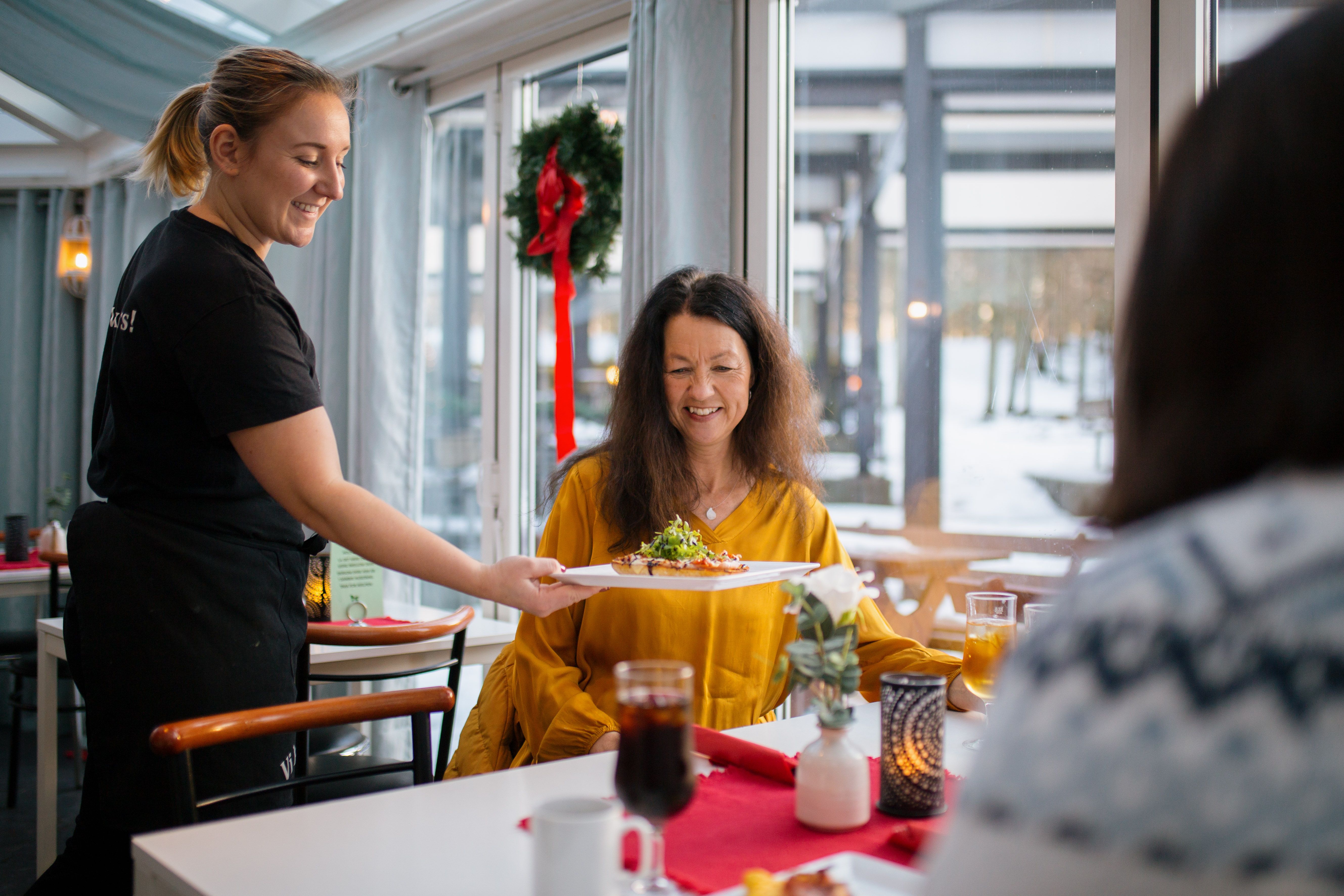 Waiter serves food on the table