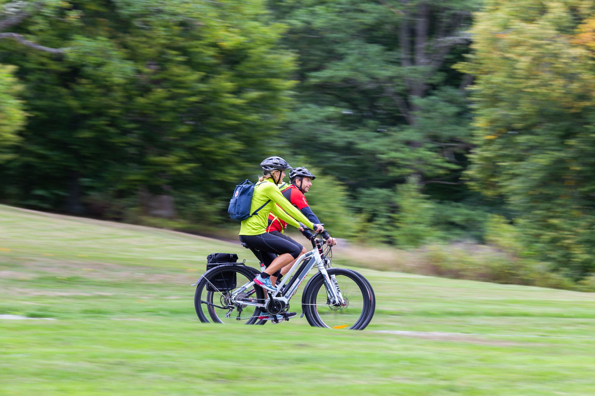  a couple going by bike in a park