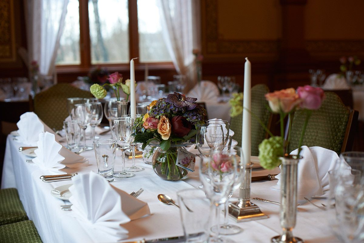 Table set with white cloth and flowers
