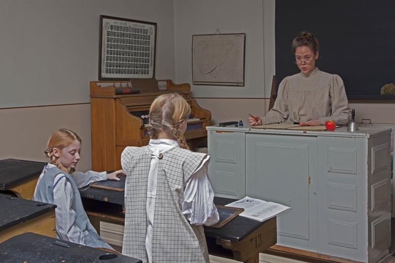 Teacher and two students in a classroom.