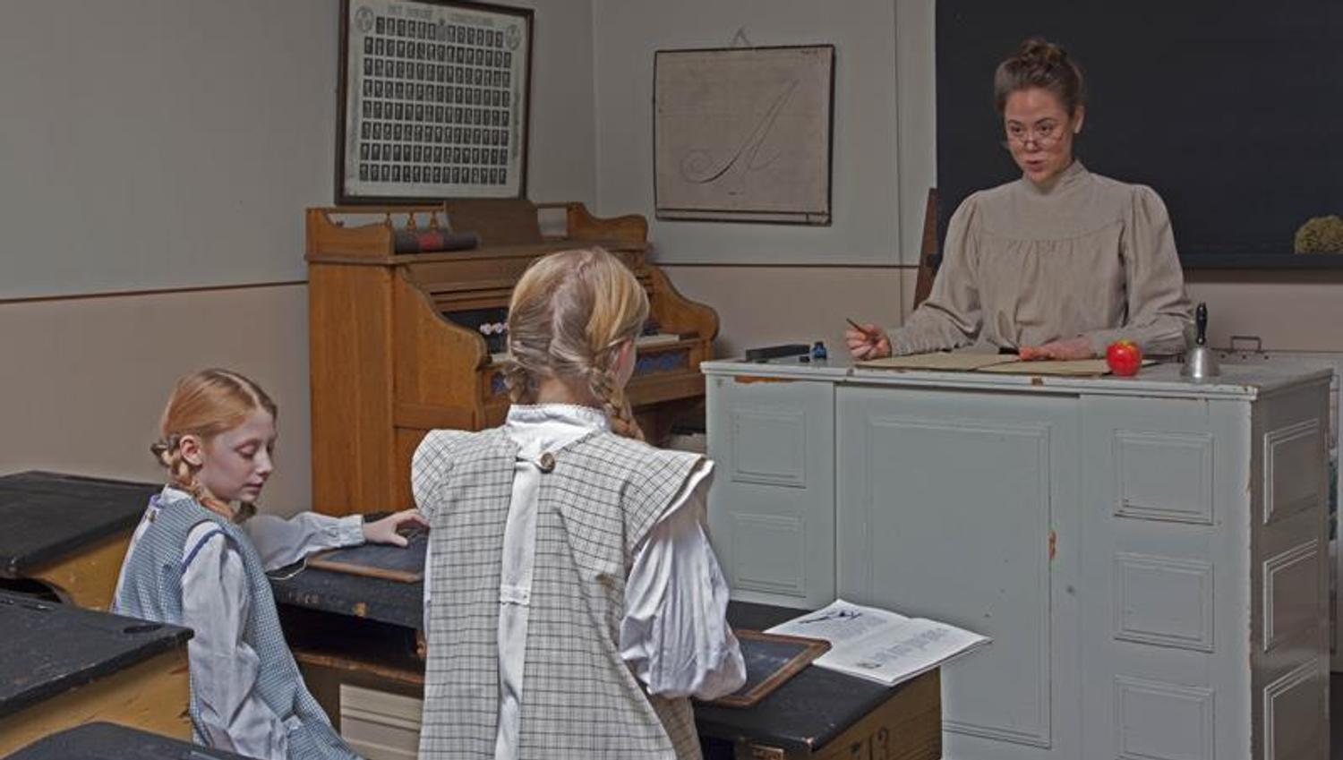 Teacher and two students in a classroom.
