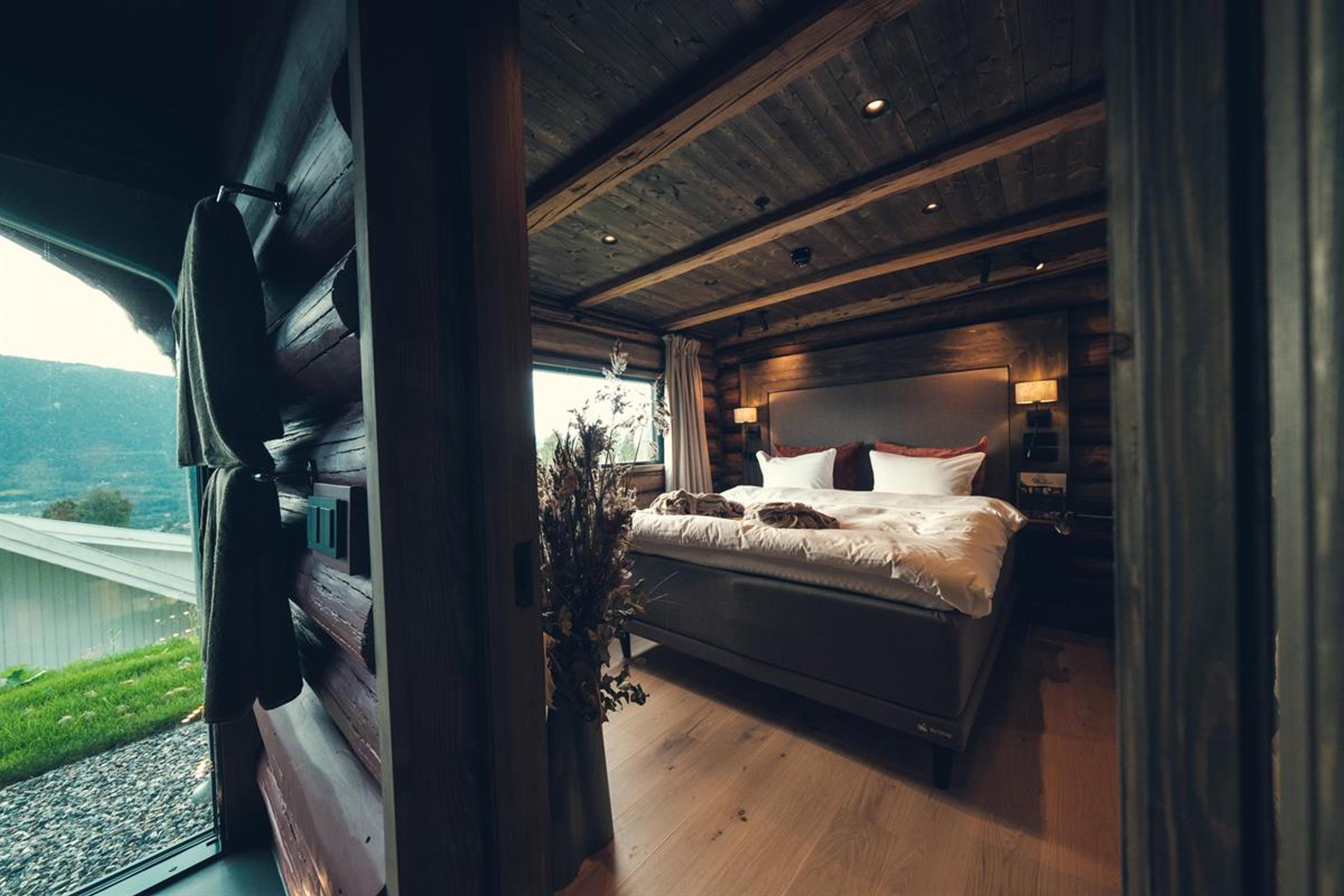 Bedroom in a traditional log-suite with a double bed.