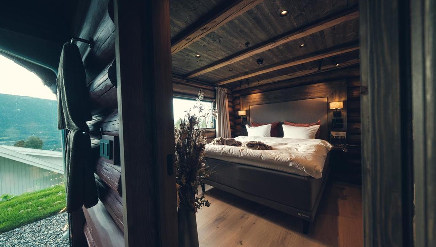 Bedroom in a traditional log-suite with a double bed.