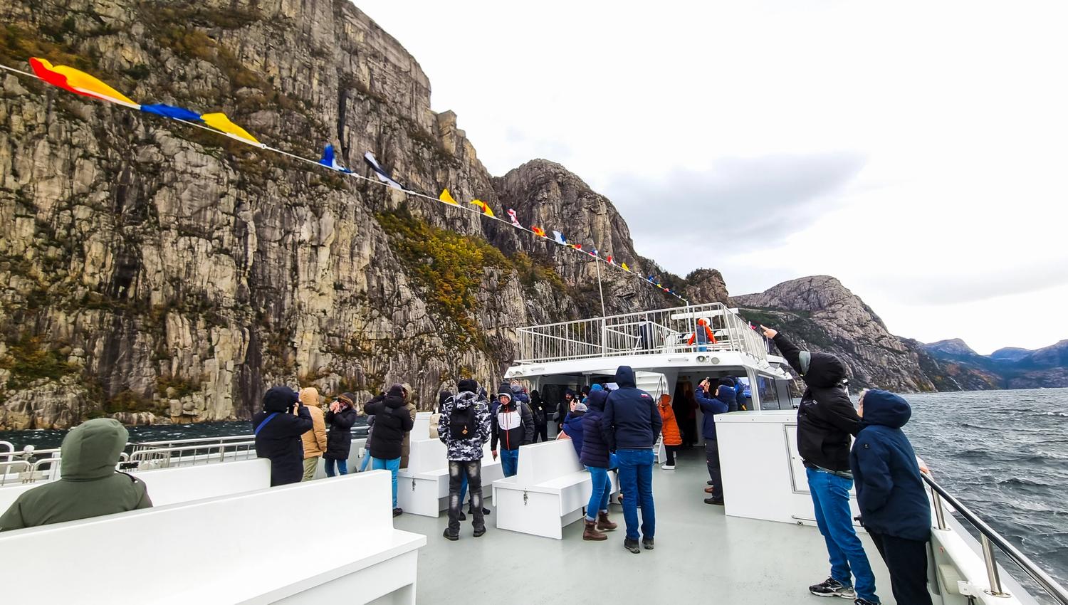 Massive rock walls towering over the fjord
