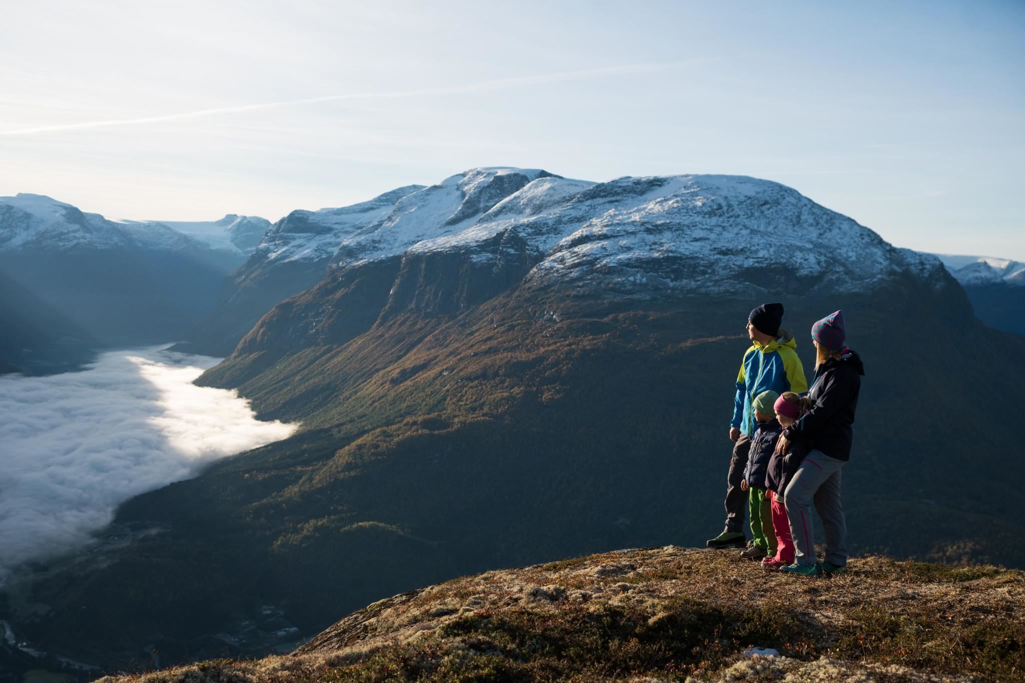 Hikers enjoying the mountain landscape and panoramic views from the hiking trails above Loen.