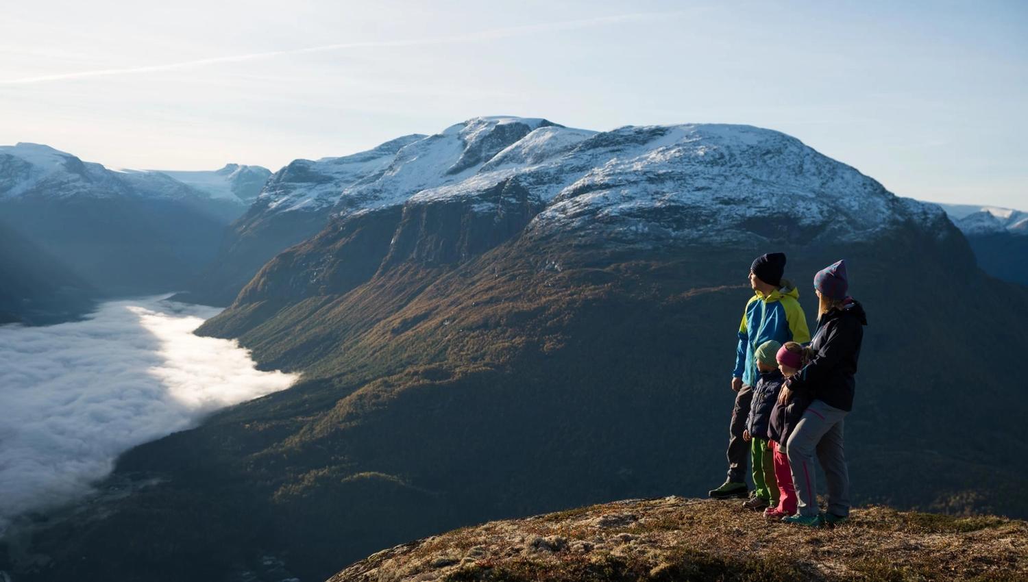 Hikers enjoying the mountain landscape and panoramic views from the hiking trails above Loen.