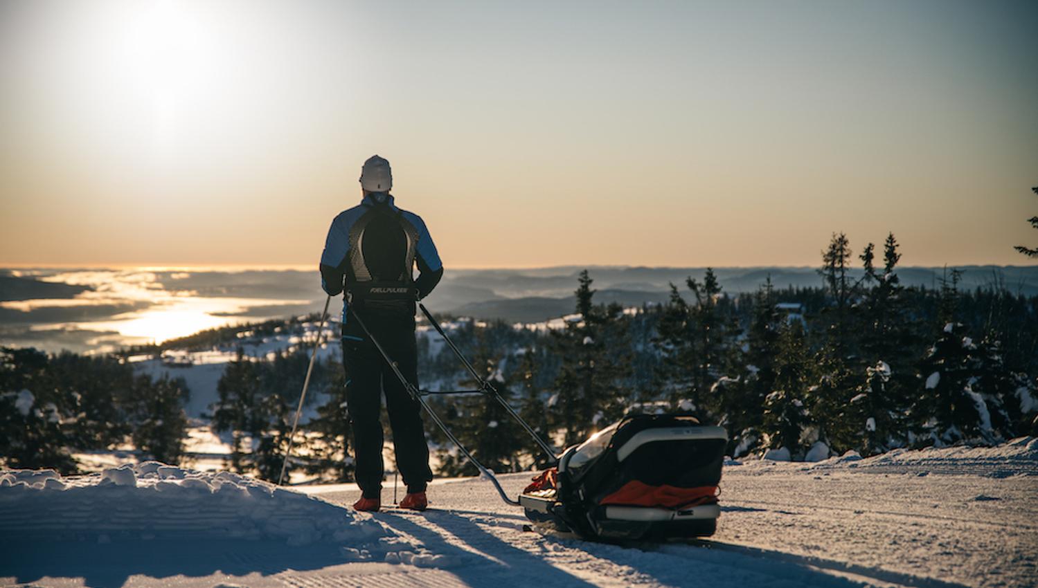 man goes cross-country skiing with sled behind him at Lifjell ski center in Bø