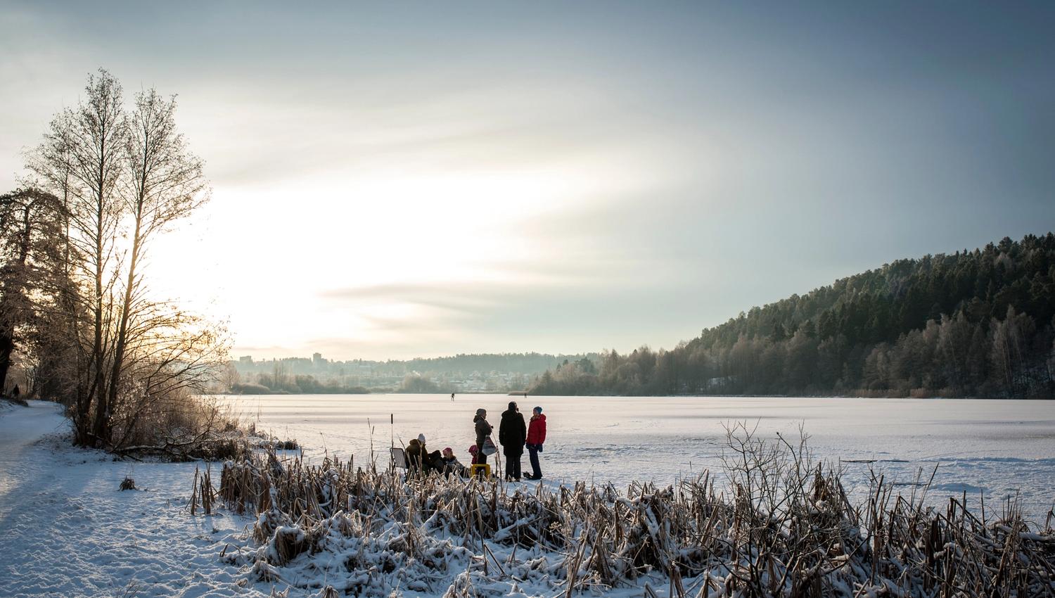 people walking on the ice-covered water