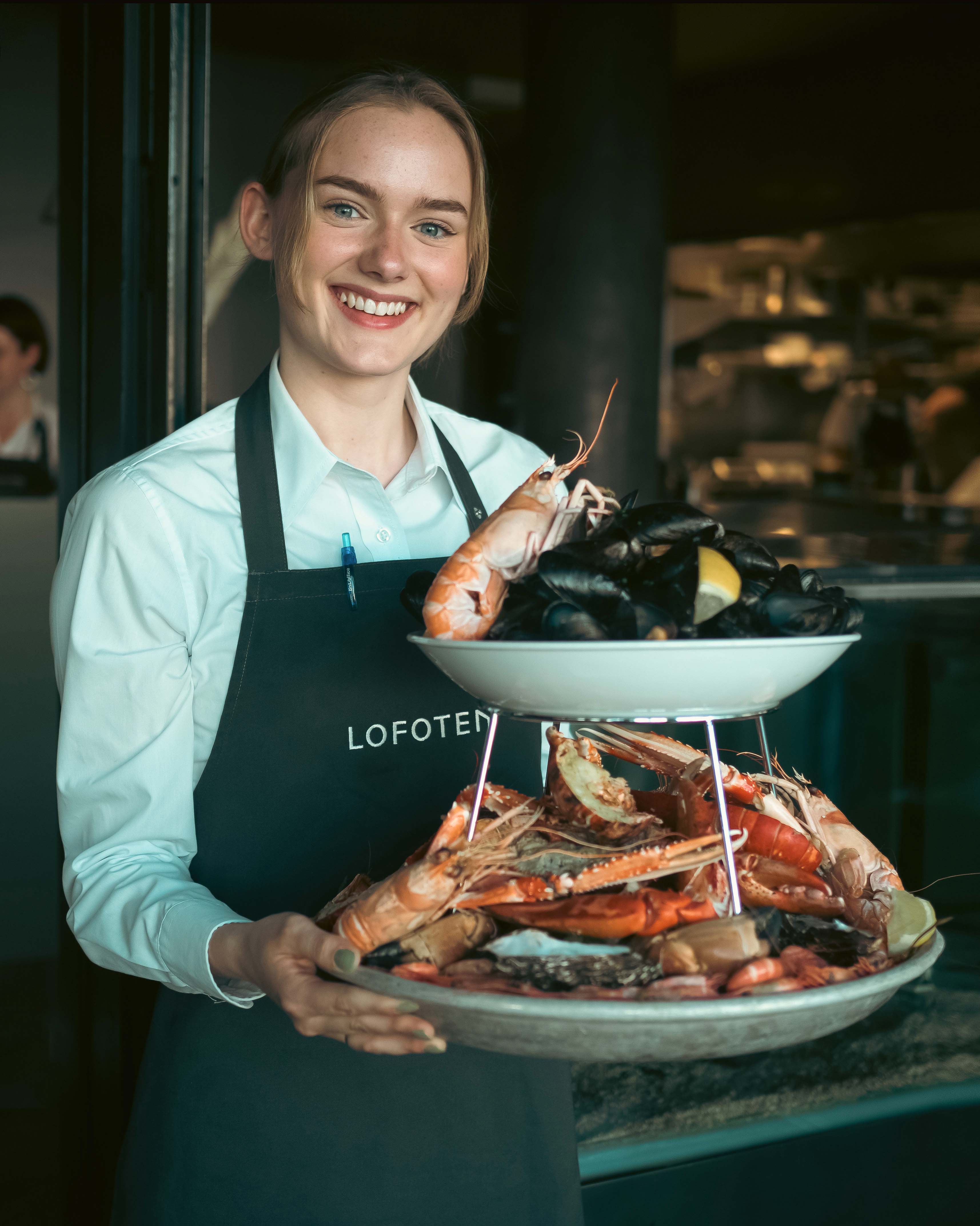 Girl holding a platter of seafood