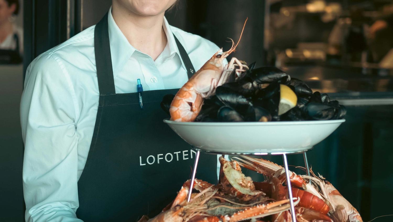 Girl holding a platter of seafood