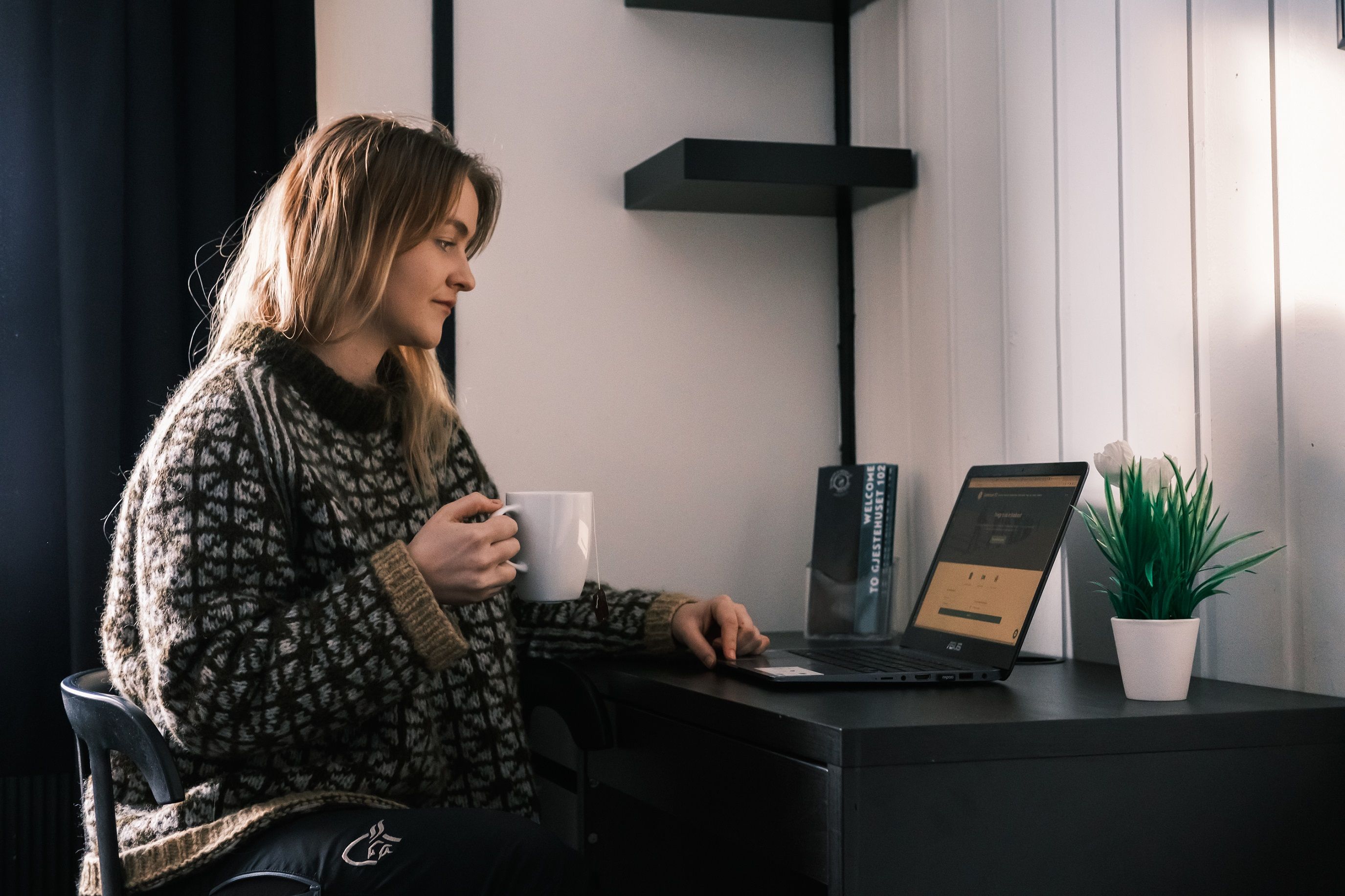 A person sitting at a desk looking at a PC screen