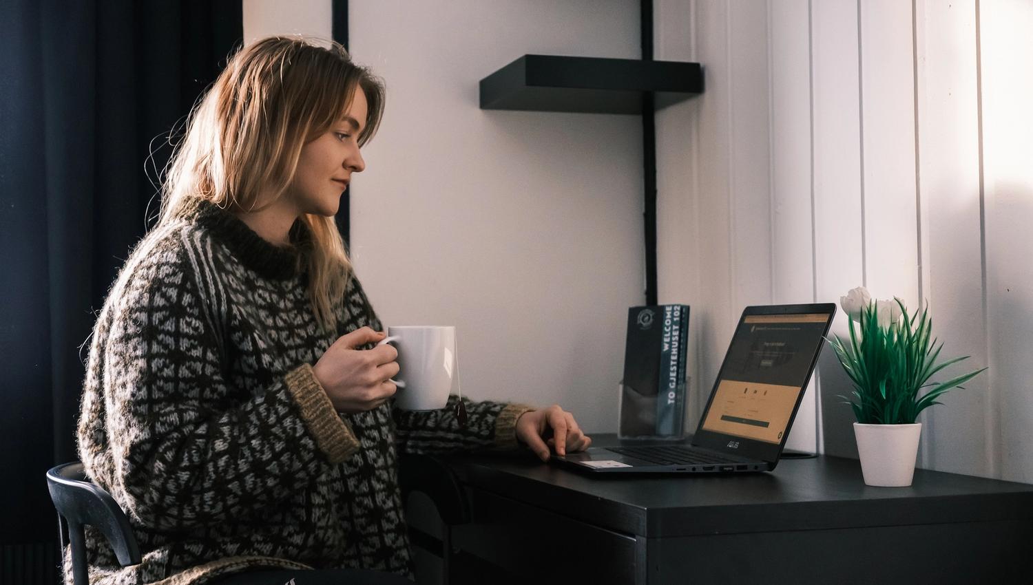 A person sitting at a desk looking at a PC screen