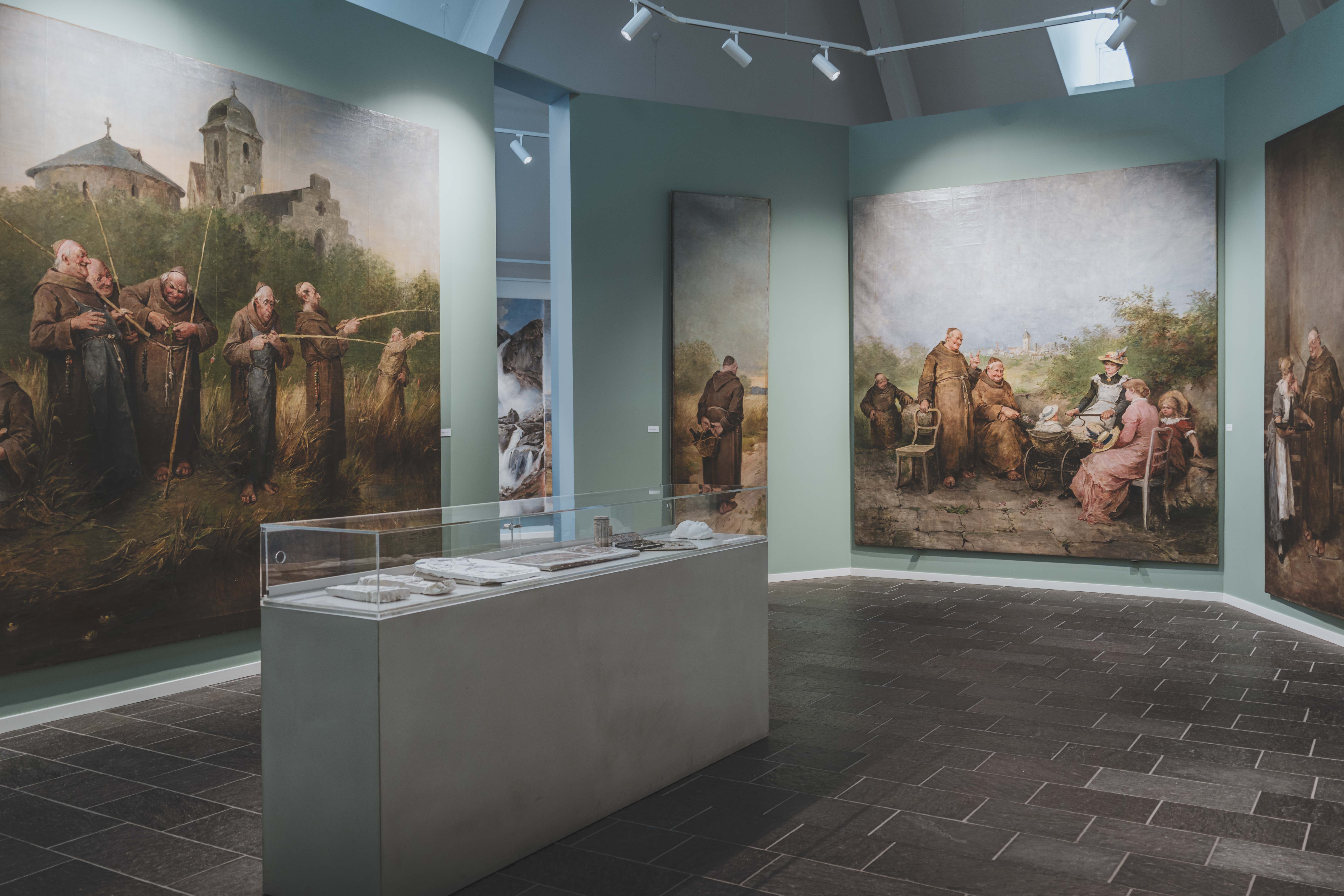 Large paintings showing monks in funny settings.