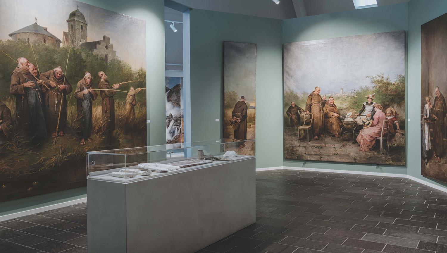Large paintings showing monks in funny settings.