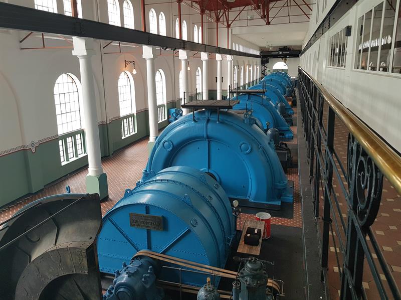 Large blue turbines inside the Kraftmuseet, showcasing historical Norwegian hydropower technology.