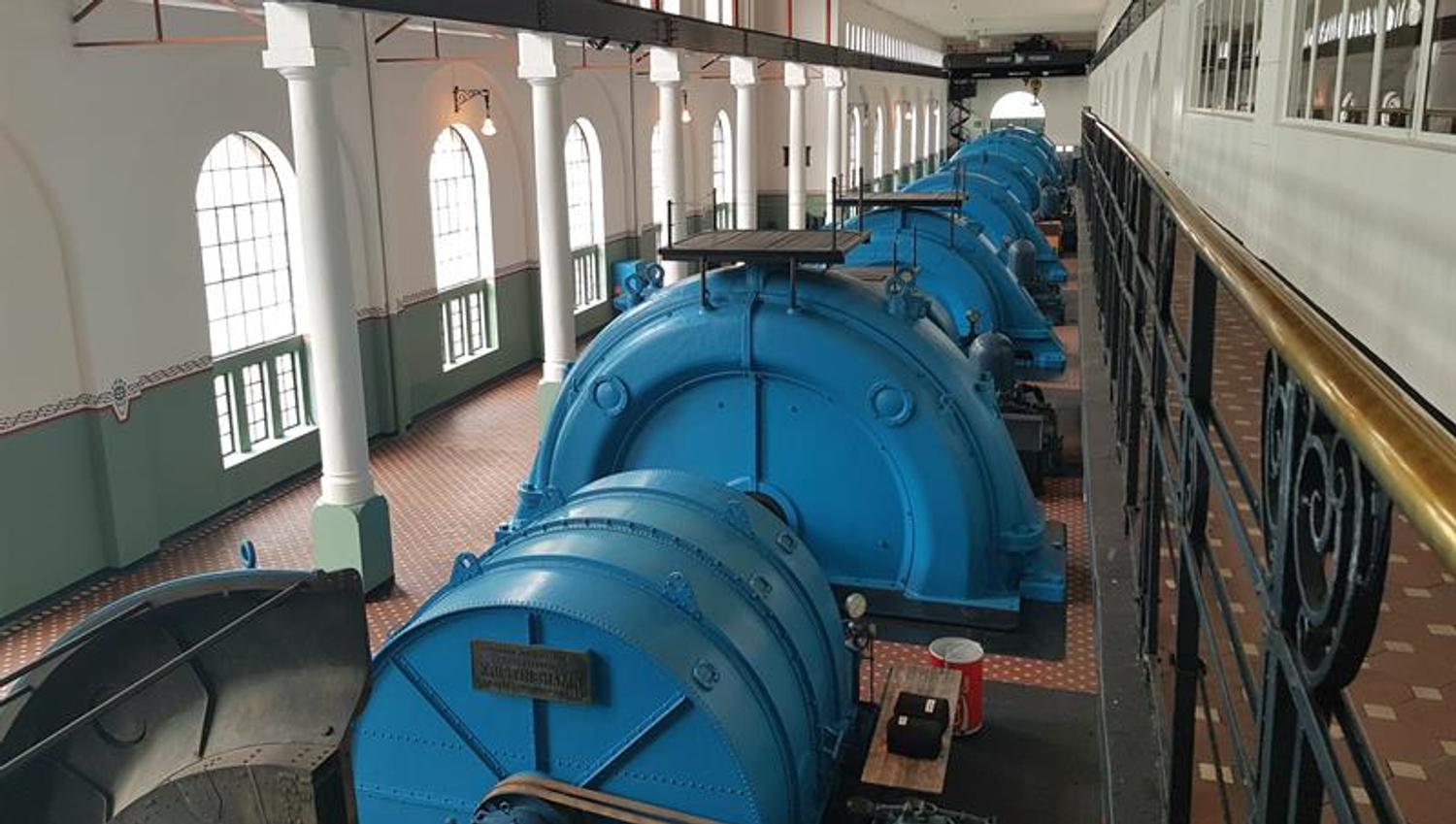 Large blue turbines inside the Kraftmuseet, showcasing historical Norwegian hydropower technology.