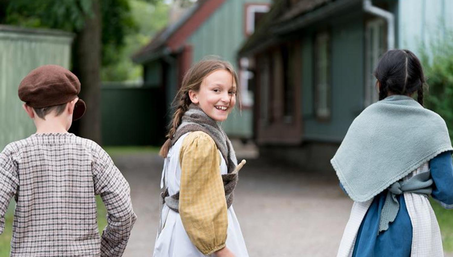 Three children in traditional clothes. Norwegian Museum of Cultural History