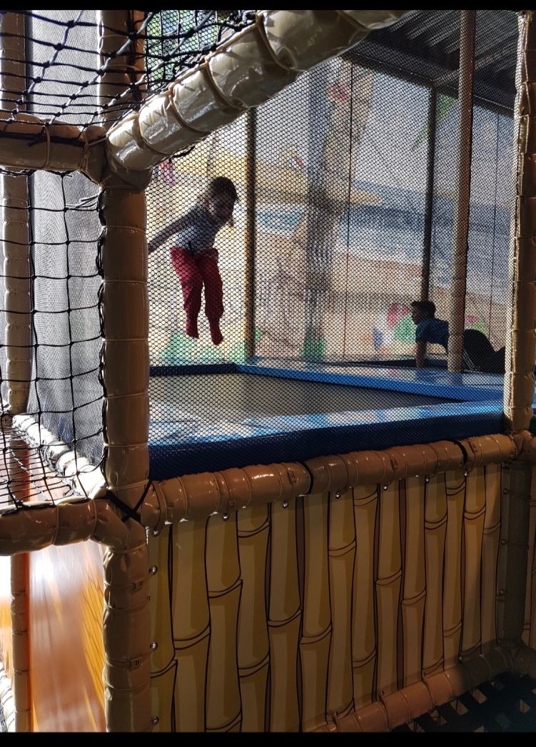 Children jump on a trampoline