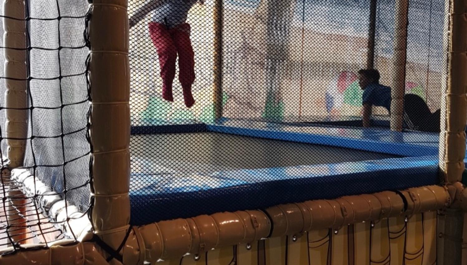 Children jump on a trampoline