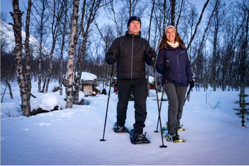 Guests walk in the snow with snow shoes