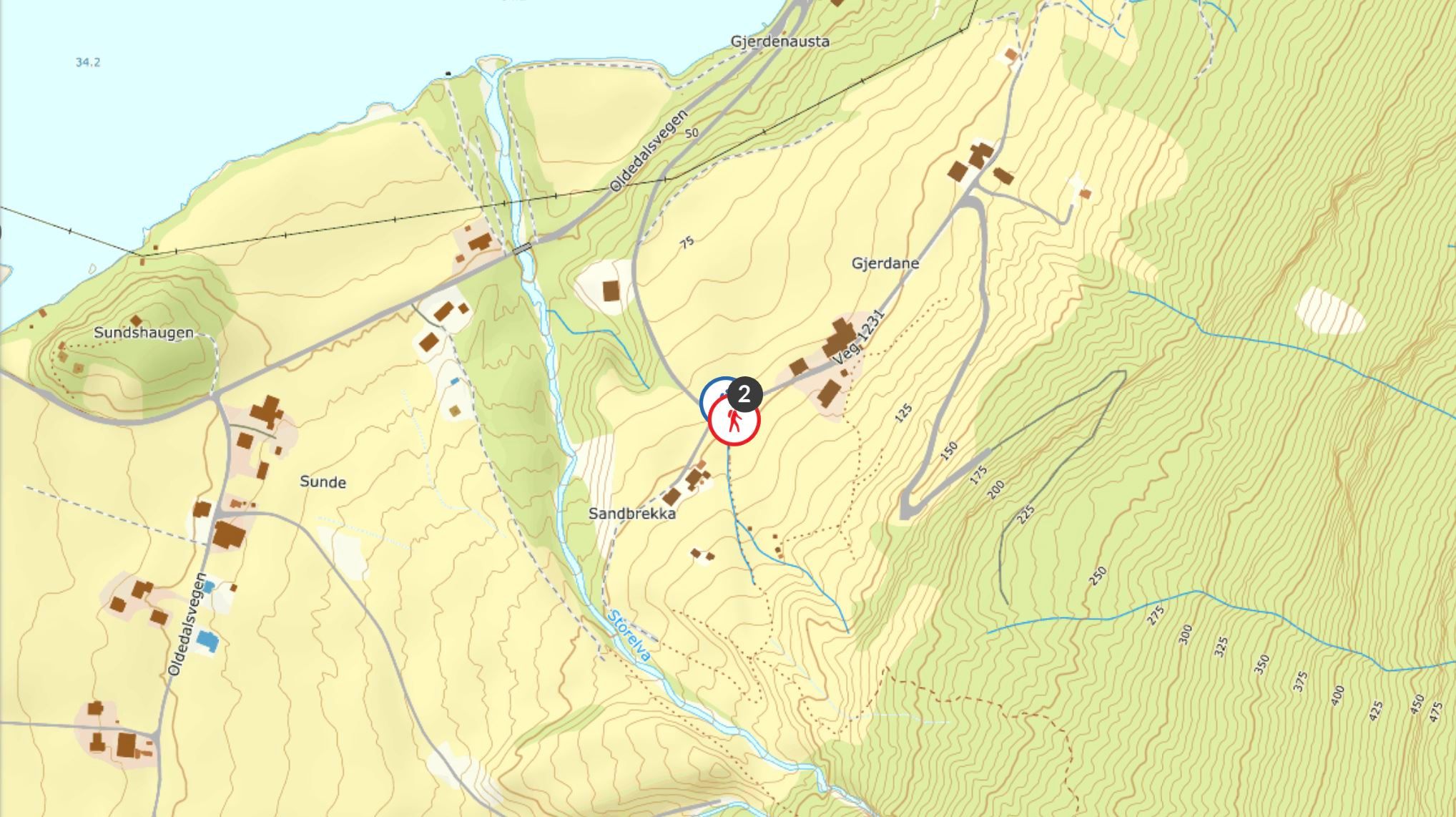 Topographic map with contour lines, roads, streams, buildings, and a red circular marker near Sandbrekka..