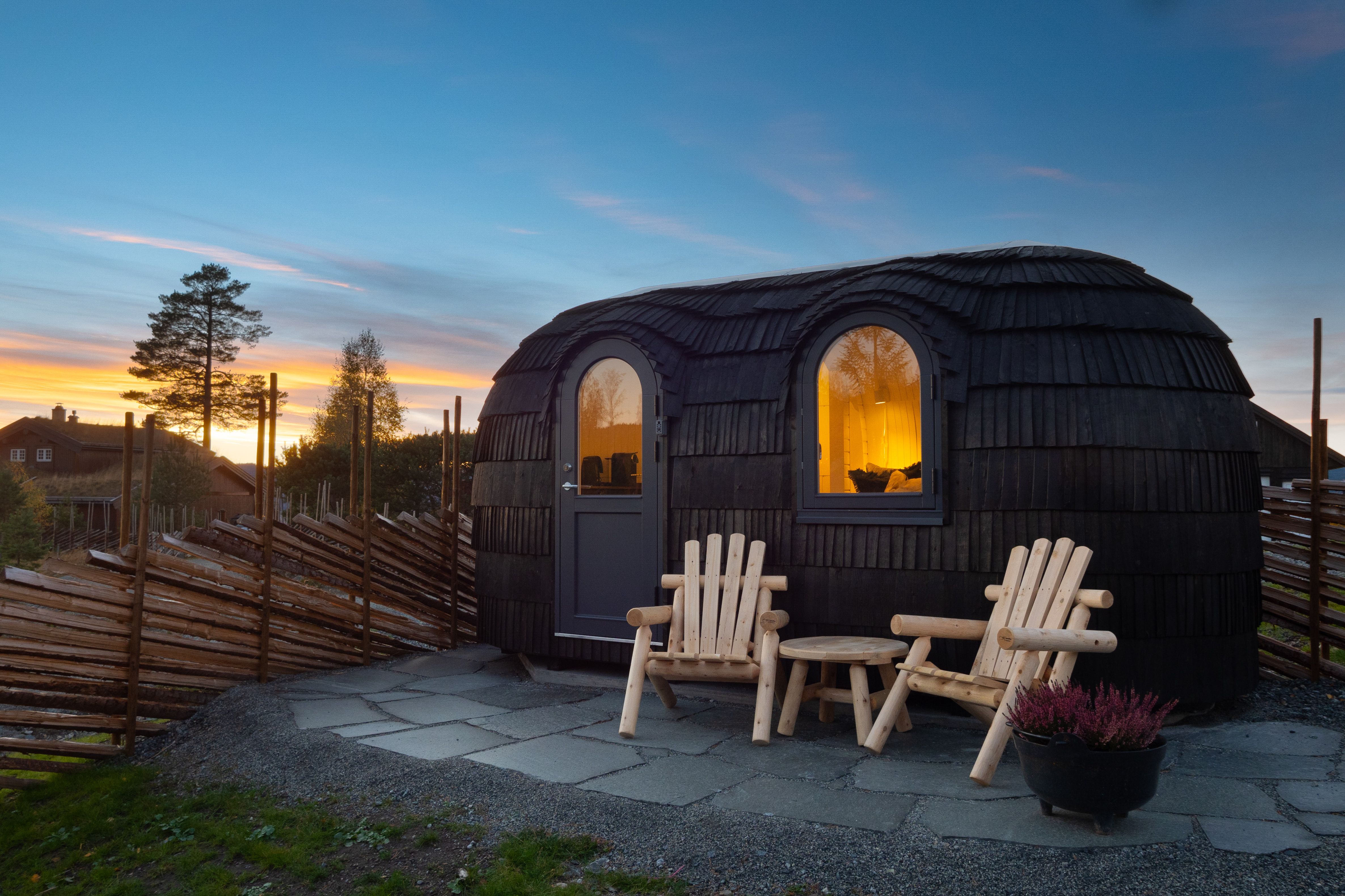 small cabin with 2 chairs in front 